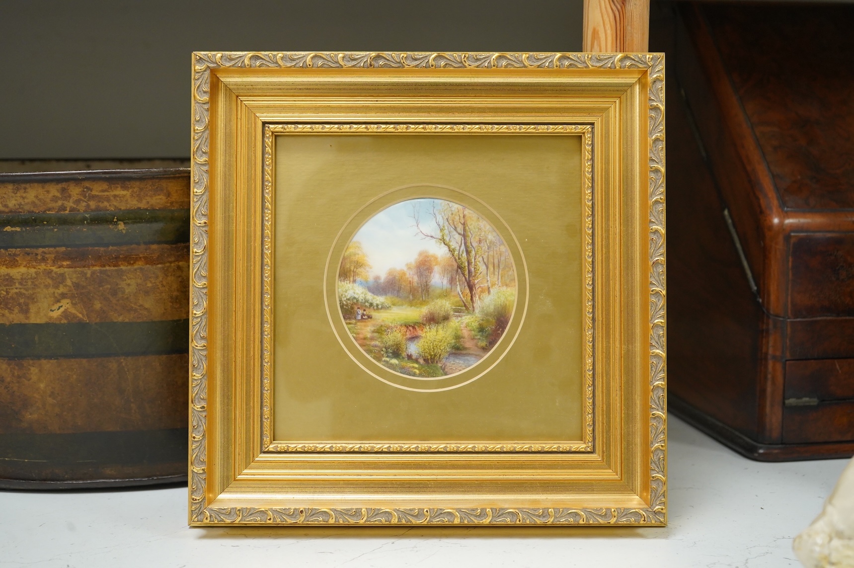 A Royal Worcester circular porcelain plaque depicting a ‘Eckley Woods’ by Raymond Rushton, gilt framed, overall 28cm high